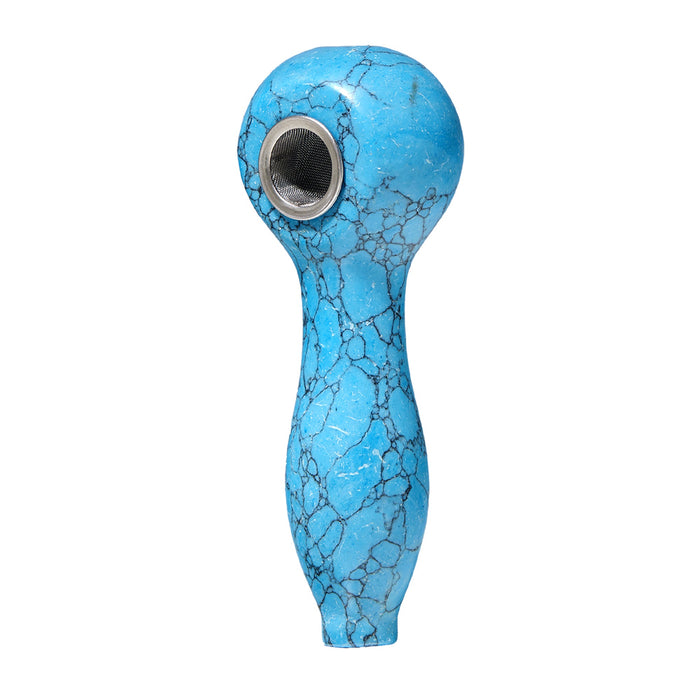 The Astral Gemstone Spoon Pipe displayed on a reflective surface, highlighting its polished finish and artistic gemstone accents, ideal for gifting or personal use.